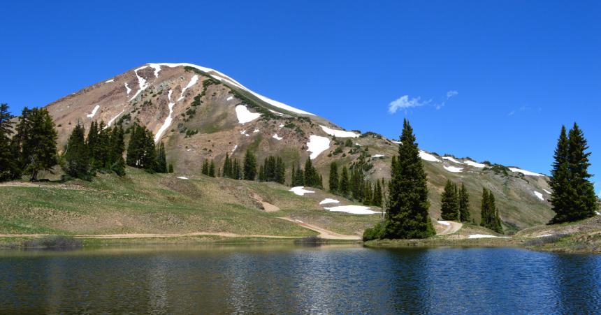 Image of rocky mountains in front of emerald lake